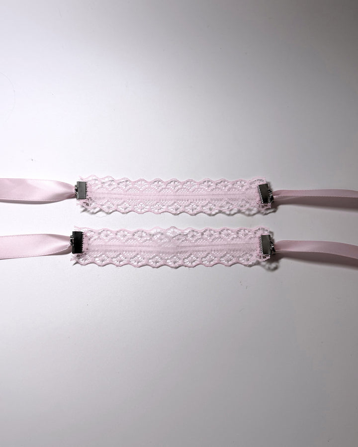 Siren Pink Lace Handcuffs Soft Bondage lied flat showing the beautiful lace floral pattern on softly lit background