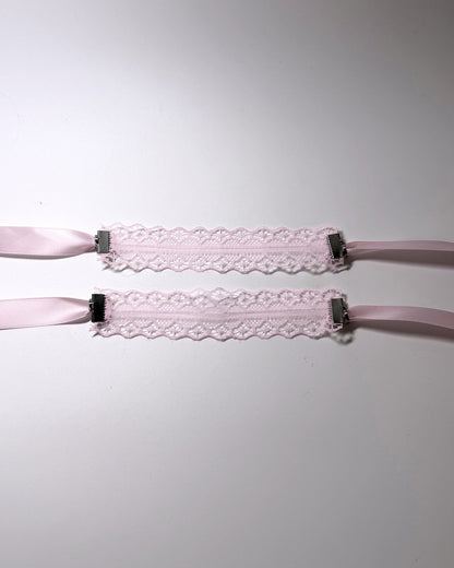 Siren Pink Lace Handcuffs Soft Bondage lied flat showing the beautiful lace floral pattern on softly lit background