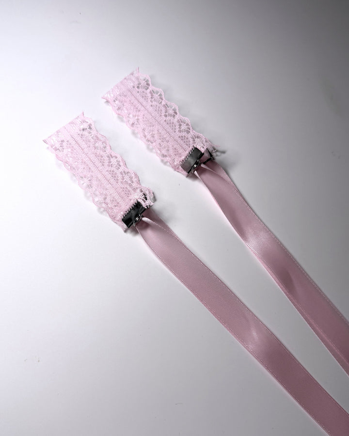 Siren Pink Lace Handcuffs showing the cuffs folded on softly lit background
