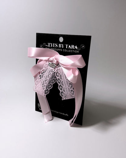 Packaging View of the Siren Pink Lace handcuffs displayed on a black card