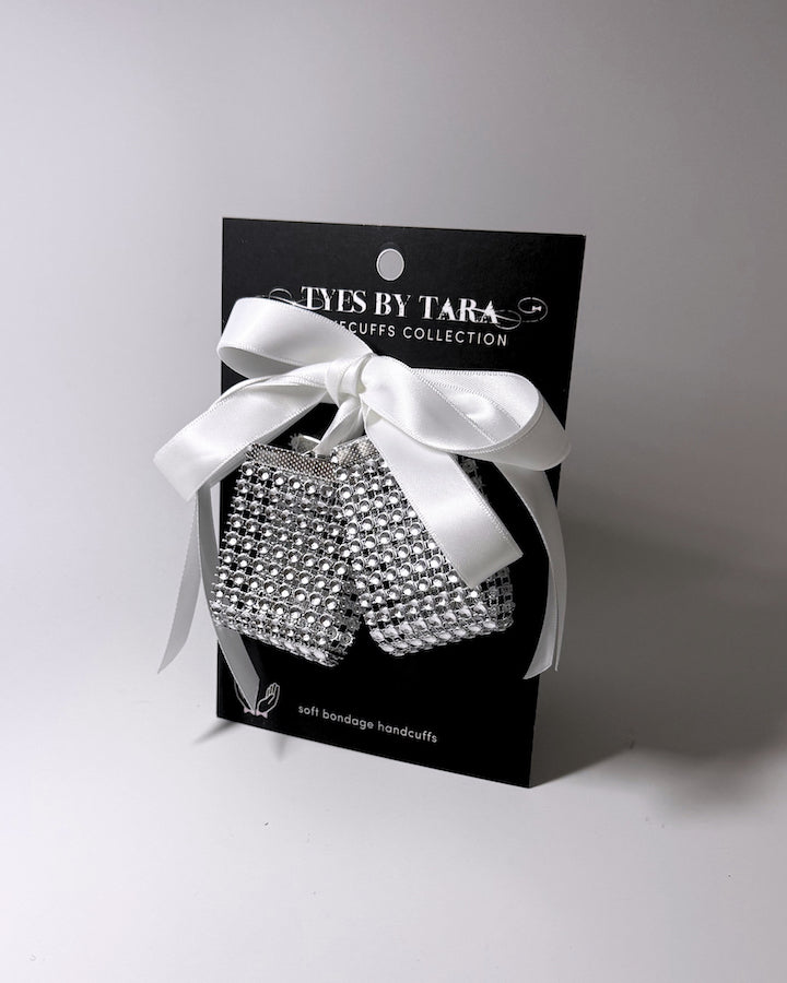 Vixen Sparkly White Rhinestone Mesh Handcuffs on light gray background displayed on a black retail card