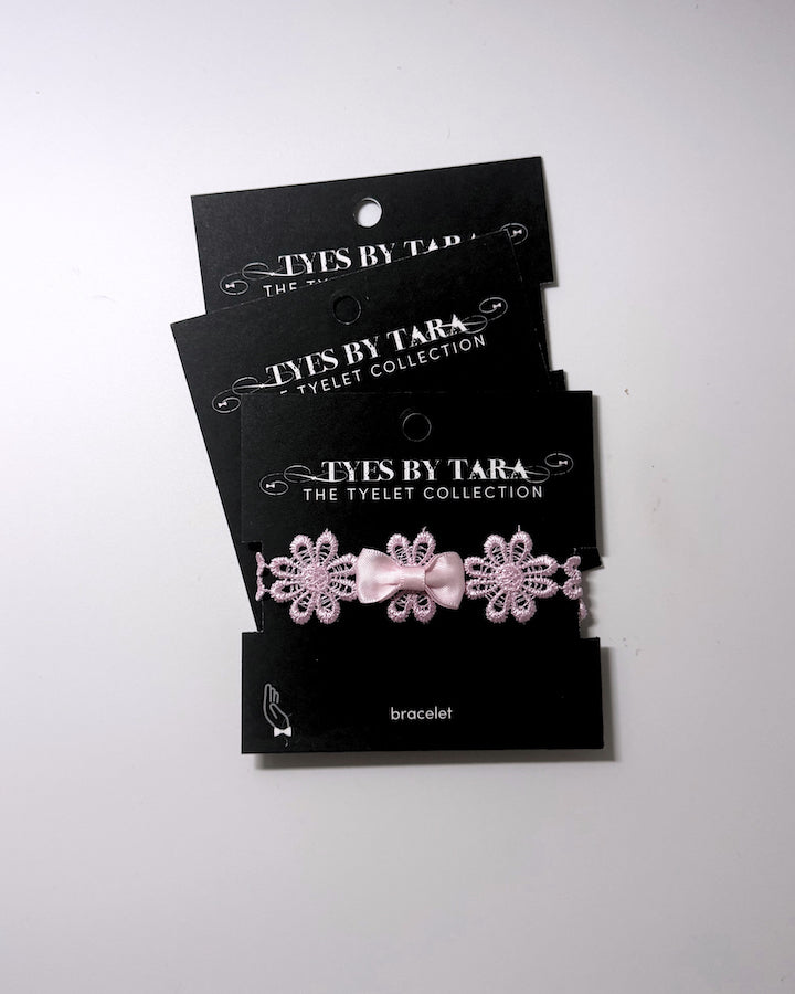 Blossom Pink Flower Bow Bracelet displayed on black retail cards in a 3 pack
