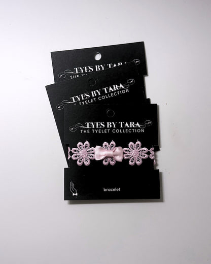 Blossom Pink Flower Bow Bracelet displayed on black retail cards in a 3 pack