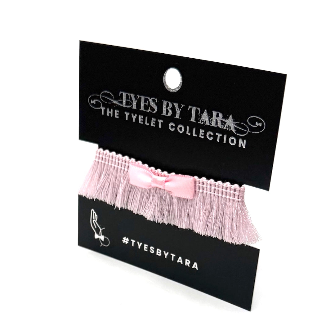 Pink Fringe with Benefits Bow Bracelet on Black Card