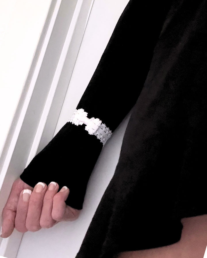 lady white elastic bow bracelet on black dress