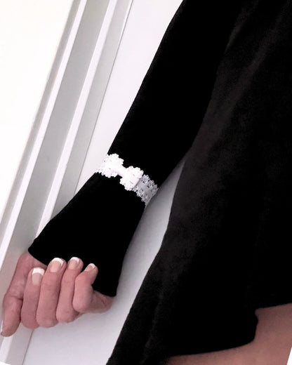 lady white elastic bow bracelet on black dress