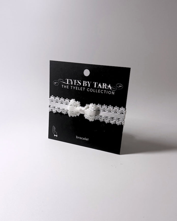 Lady White Elastic bow bracelet on black card