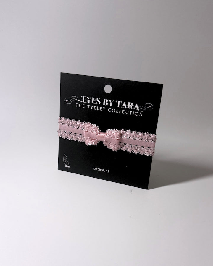 Pink Bow Bracelet on retail display black card