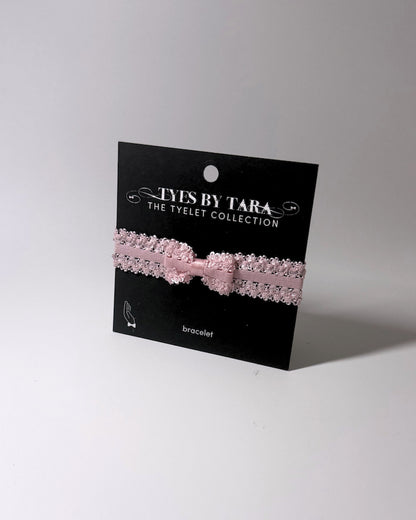 Pink Bow Bracelet on retail display black card