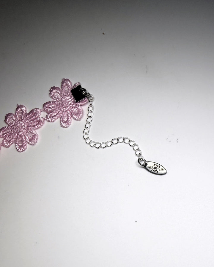 Pink Flower Bow Bracelet showing extender chain with logo tag