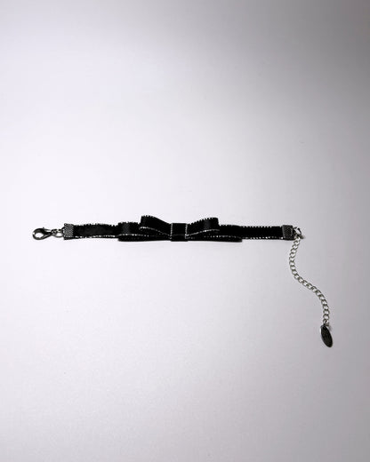 queen black metallic trimmed bow bracelet flatlay