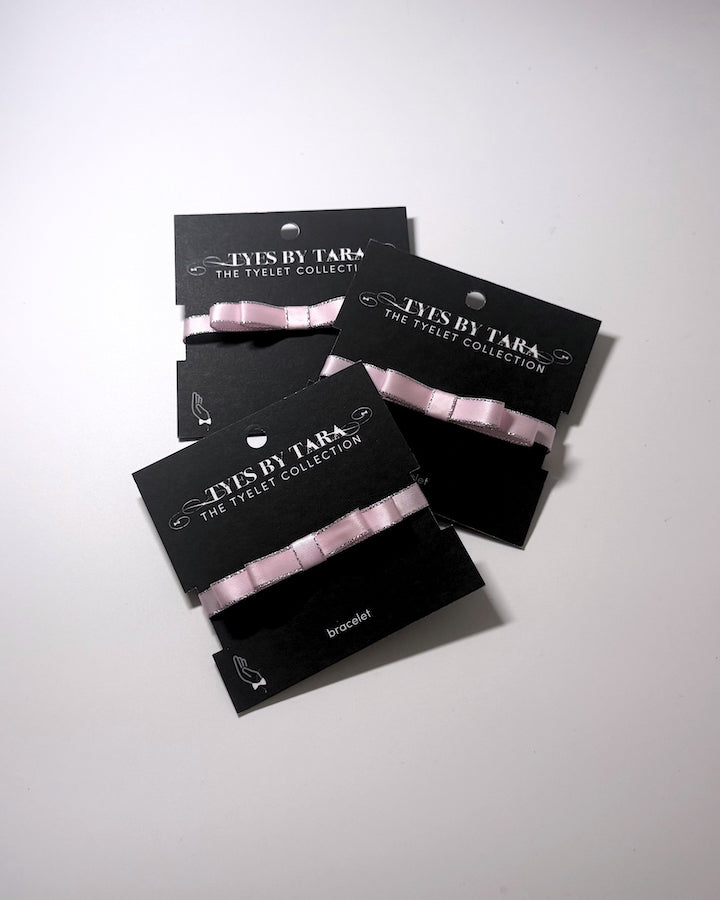 Three Pack of Queen Pink Bow Bracelets on light white background