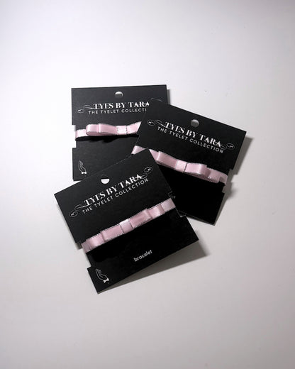 Three Pack of Queen Pink Bow Bracelets on light white background
