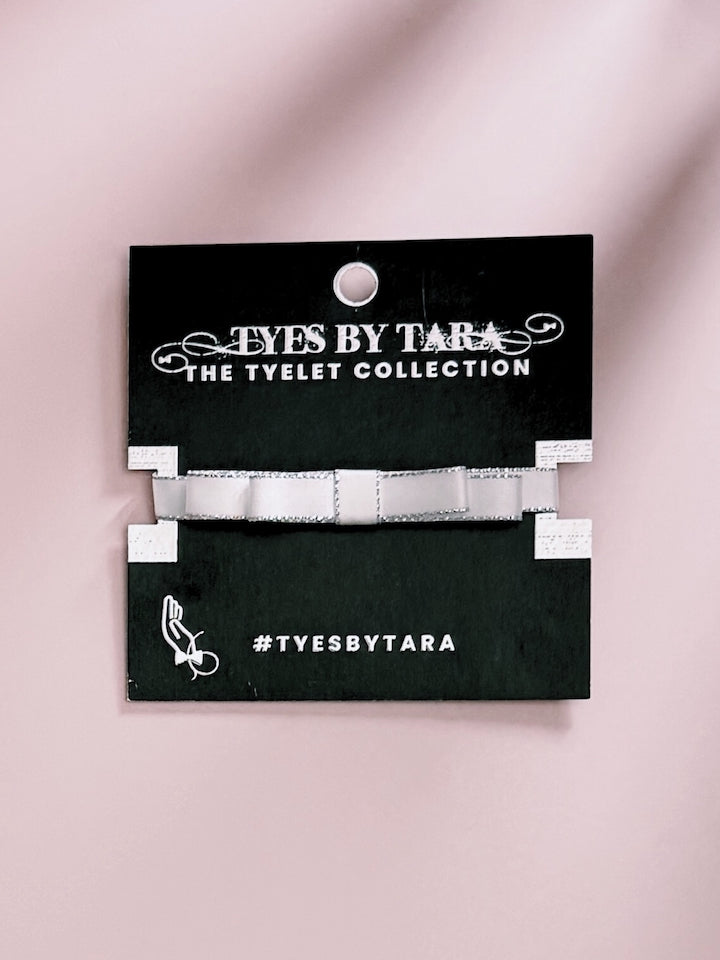 White Silver Bow Bracelet on Black Card Packaging View