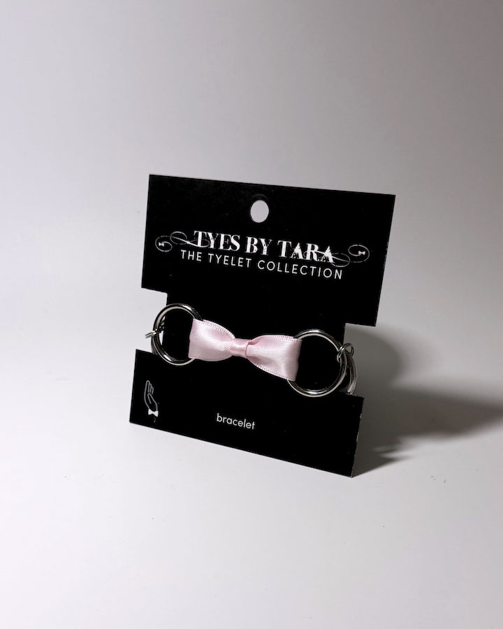 Runaway Pink Bow Bracelet with Stainless Steel O Rings on Black Card