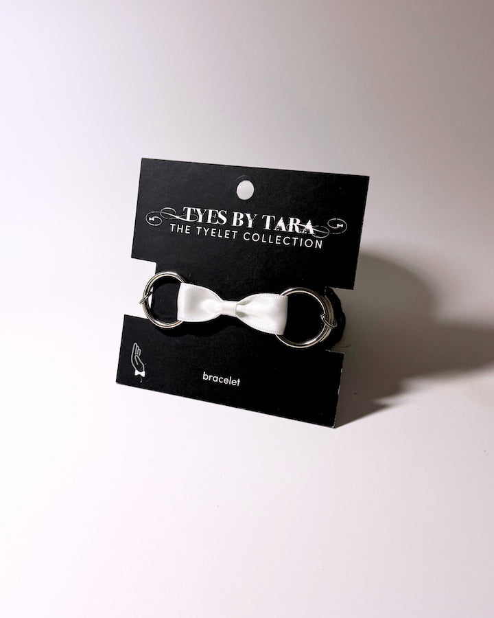 Runaway White Bow Bracelet on Black Card