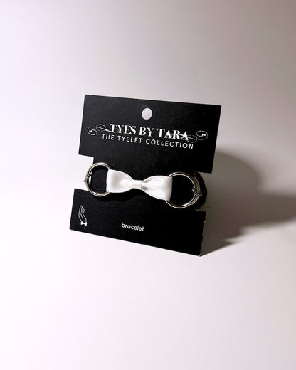Runaway White Bow Bracelet on Black Card