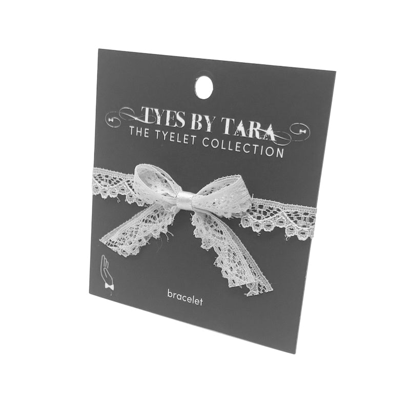 white tease lace bow bracelet on black card