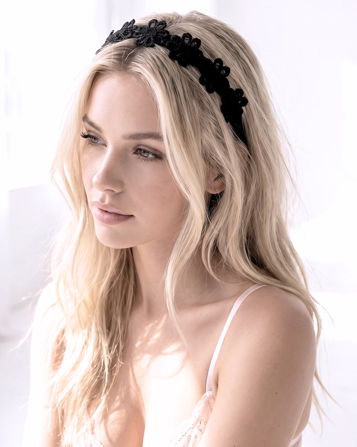 Blonde Model wearing the Black Flower Bow Headband in white room
