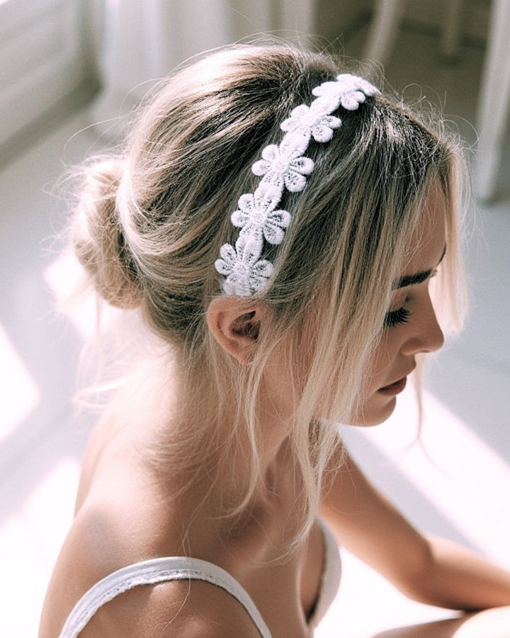 Blonde model wearing the Blossom White Flower Headband with a pretty updp hairstyle