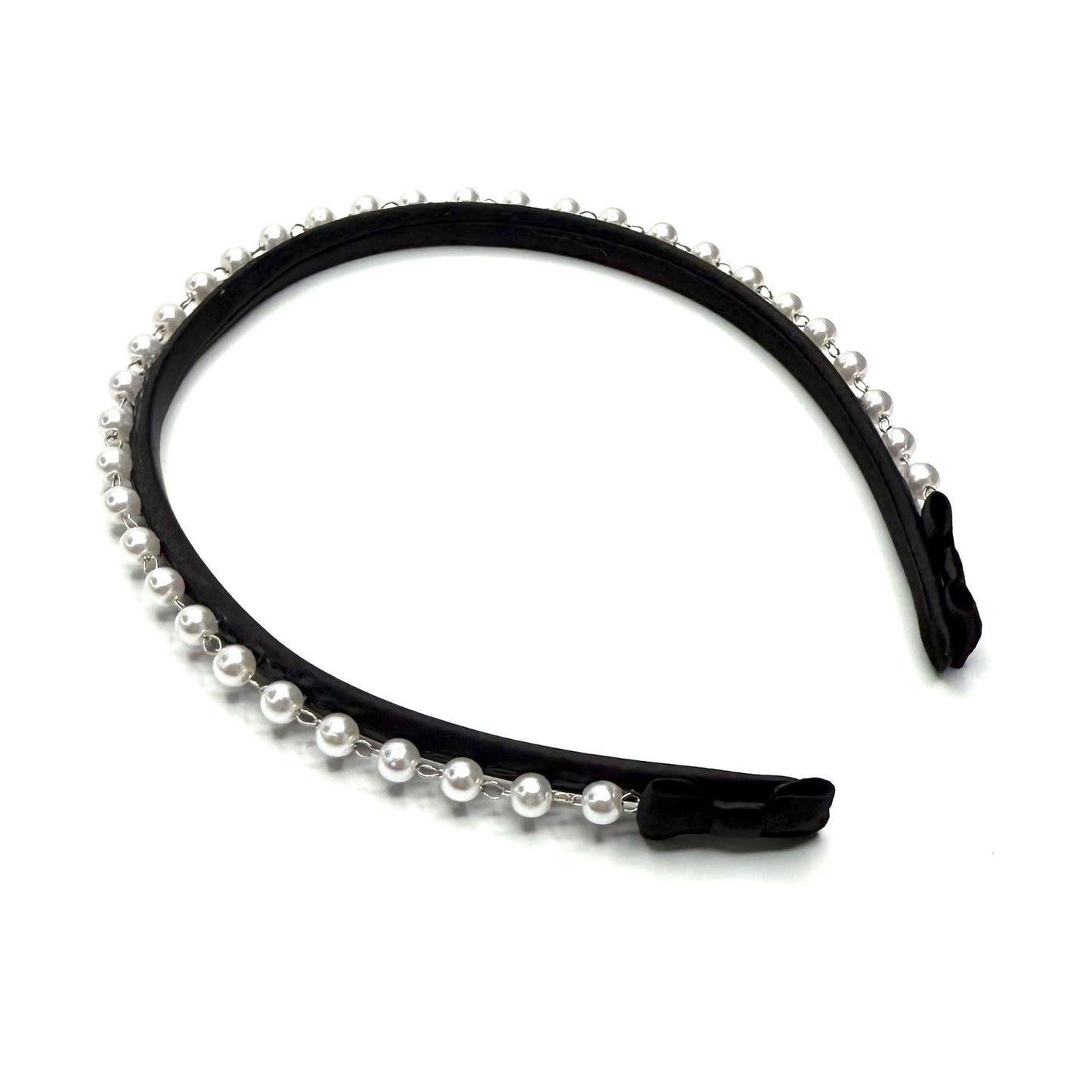 Black headband with pearl accents on a white background