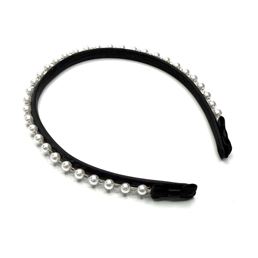 Black headband with pearl accents on a white background