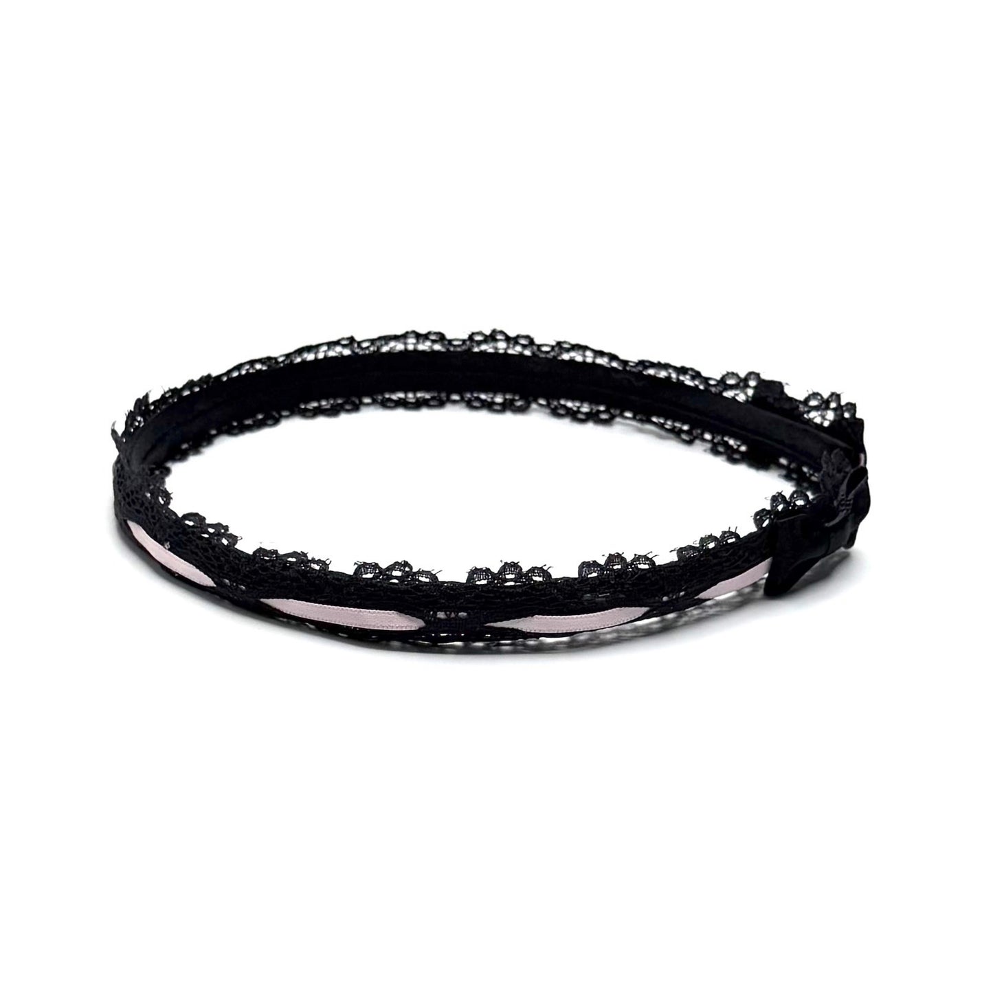 Black lace headband on a white background side view with black bows