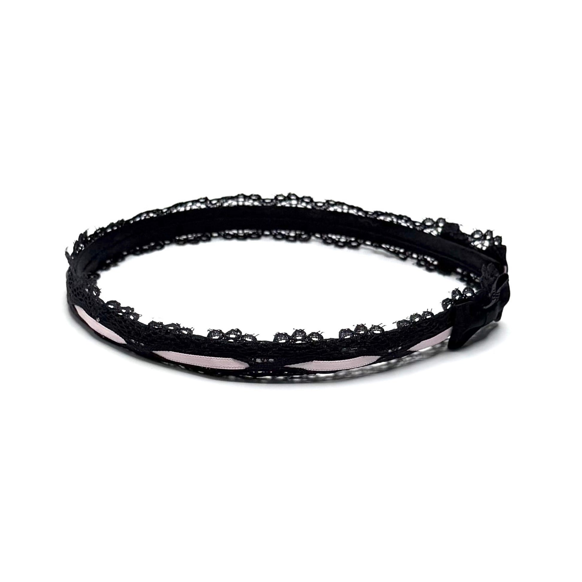 Black lace headband on a white background side view with black bows