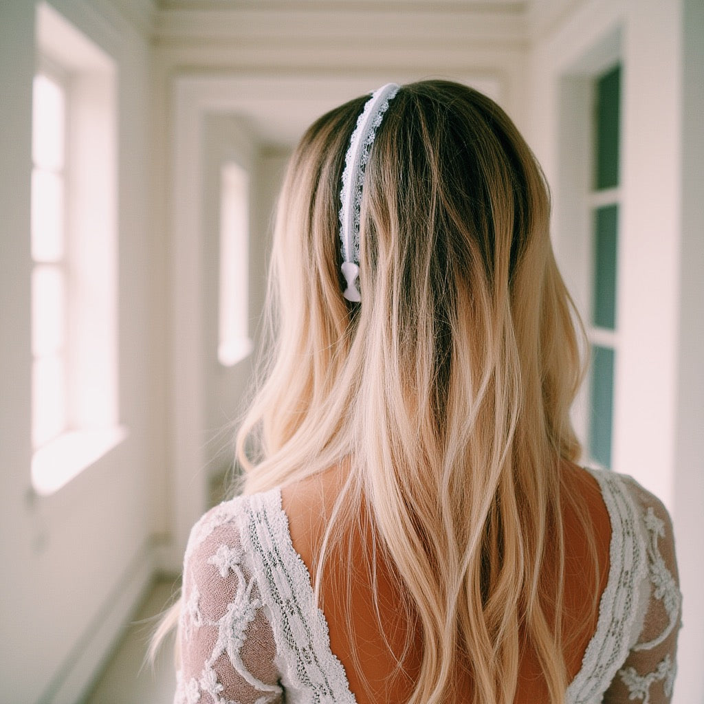 Beautiful blonde wearing chantilly white lace headband in wedding dress facing away showing the bow at the end