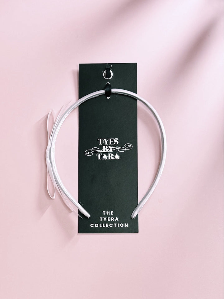 Packaging View of Enchantress White Bow Satin Headband 