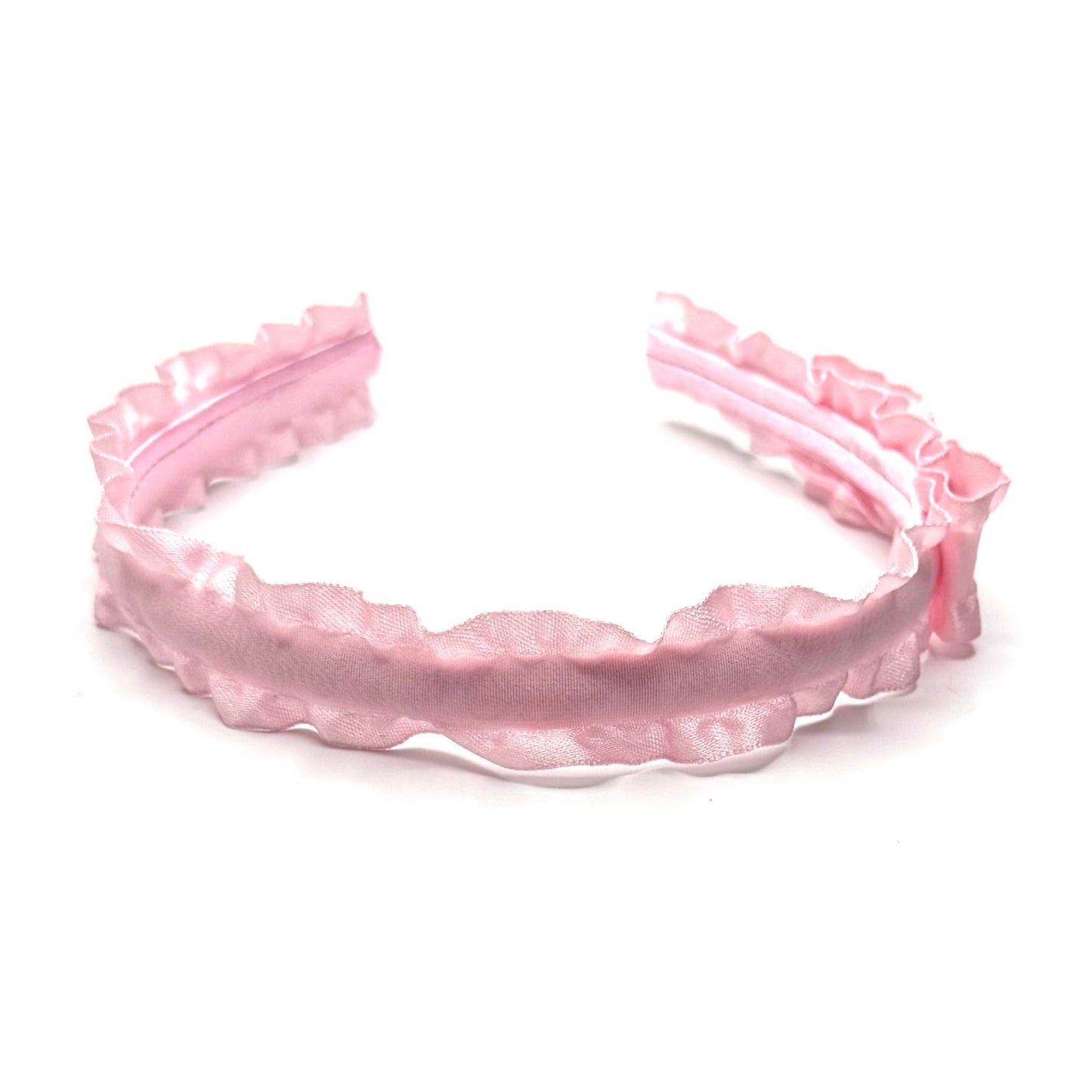 Pink ruffled  headband on a white background top view