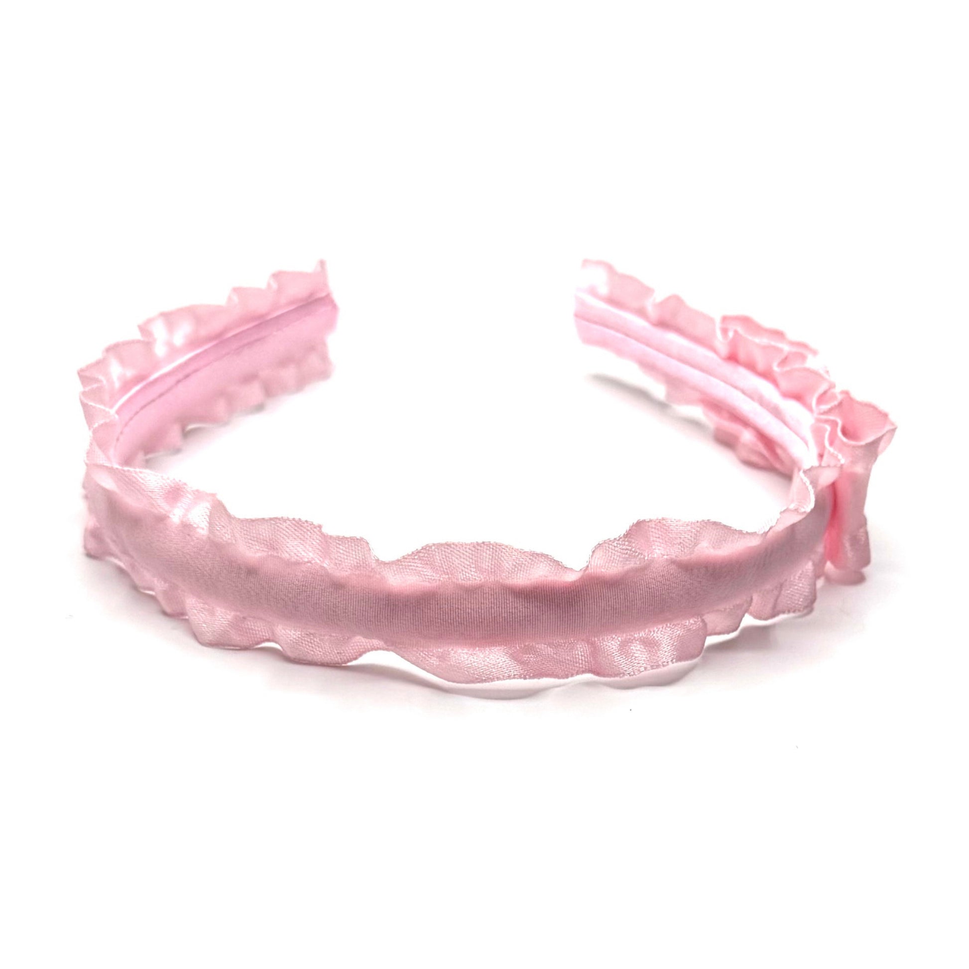 Pink ruffled  headband on a white background top view