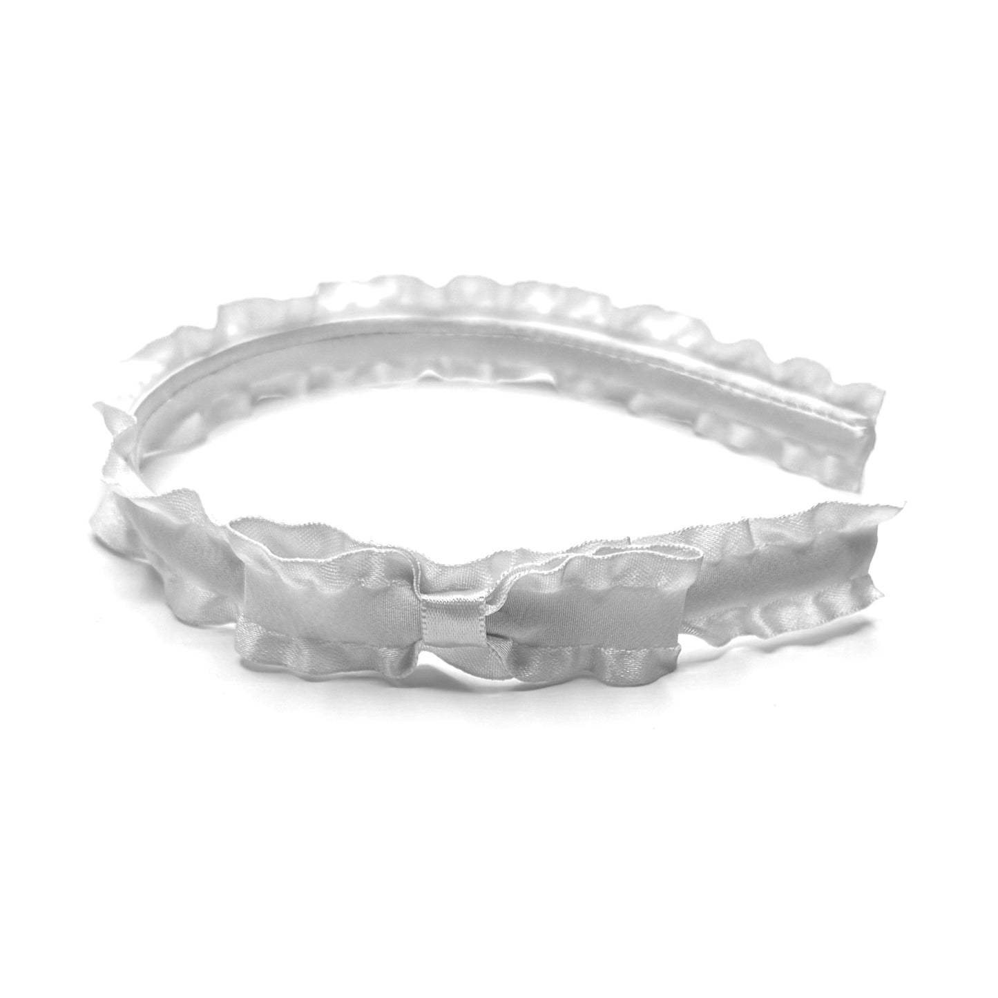 White ruffled headband with textured design on a white background