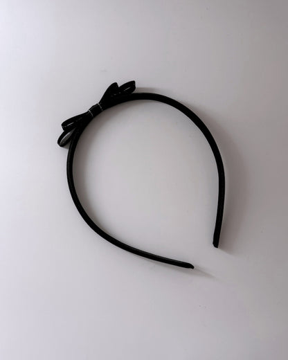 Black Bow Headband with black bow on top of crown