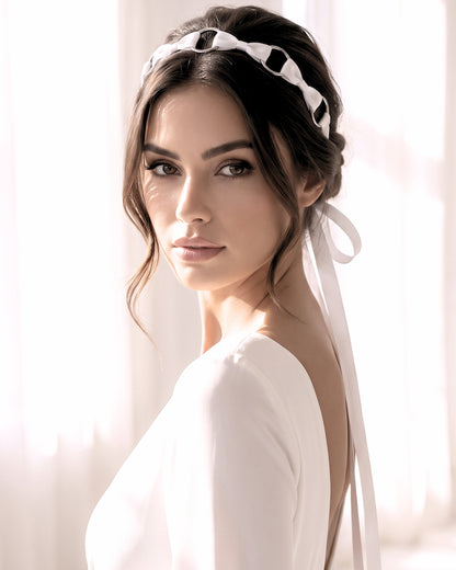 Beautiful Model in Runaway Pink Bow Headband with long satin ties in wedding dress