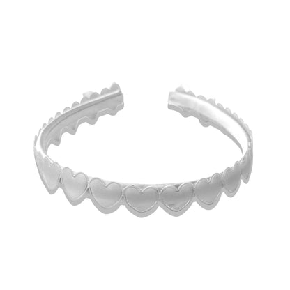 white heart bow headband on white background top view
