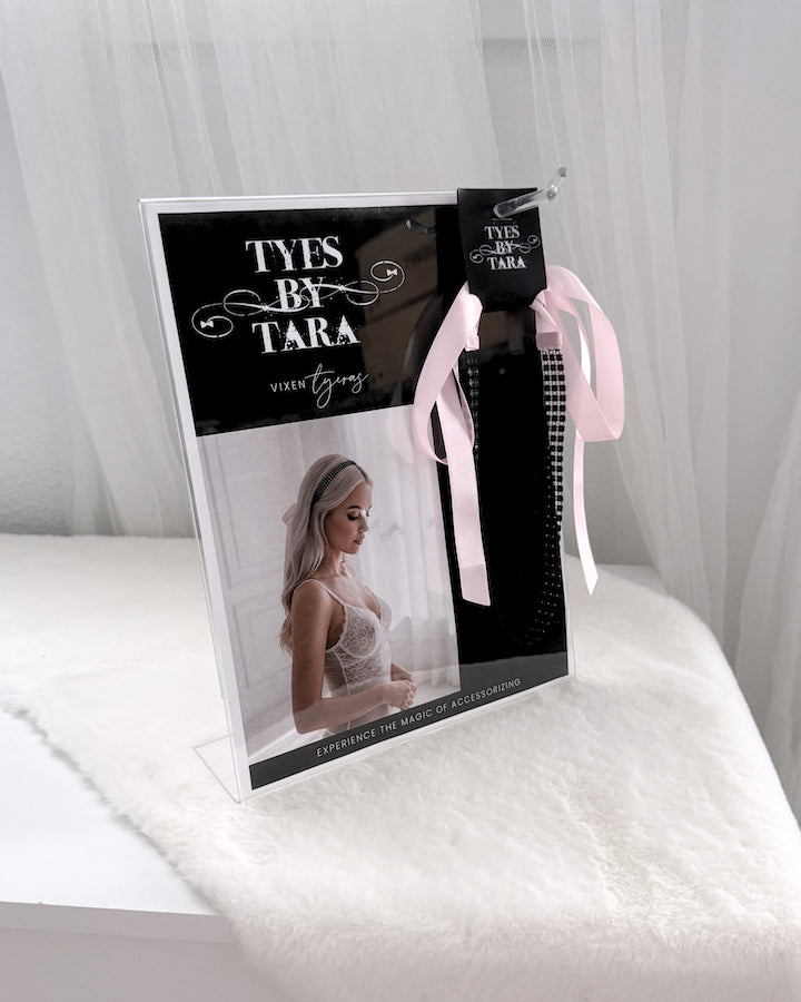 A clear acrylic display for the Vixen Sparkly black headband retail display kit