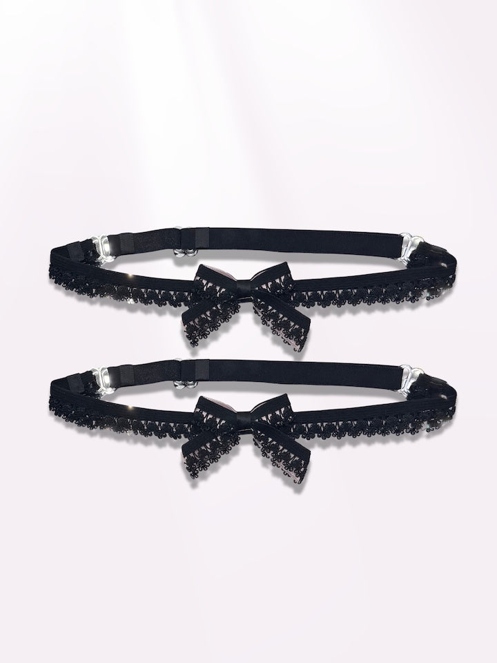 Expanded view of the belle black bow leg garters on light pink background