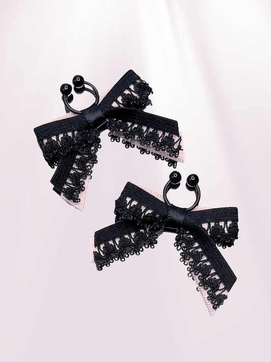 Black Bow Nipple Clamps on Pink Background