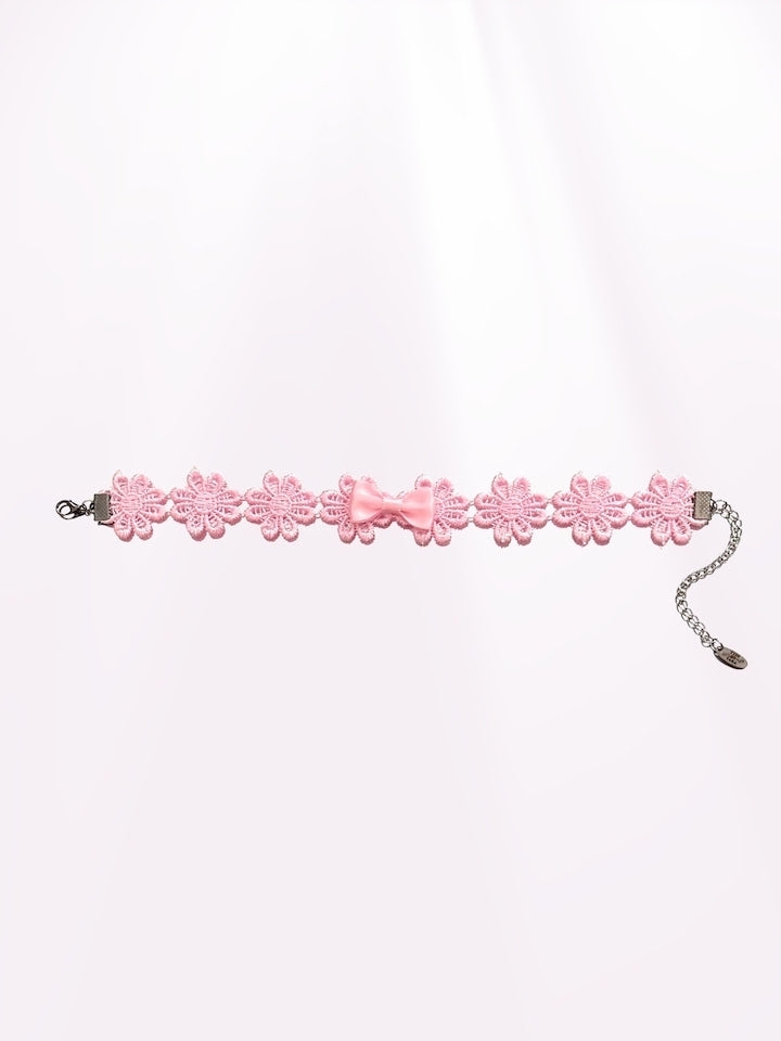 flatlay view of pink blossom bow flower anklet