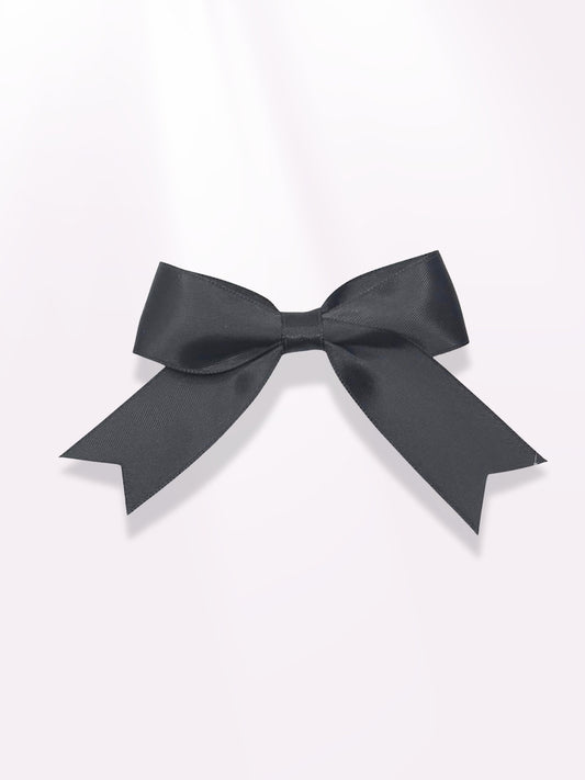 Black Bow Barrette on Light Pink Background
