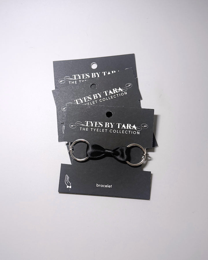 Runaway Black Bow Bracelet displayed in a 3 pack