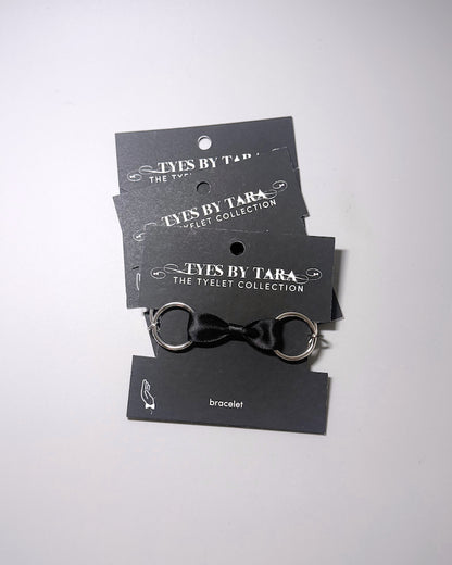 Runaway Black Bow Bracelet displayed in a 3 pack
