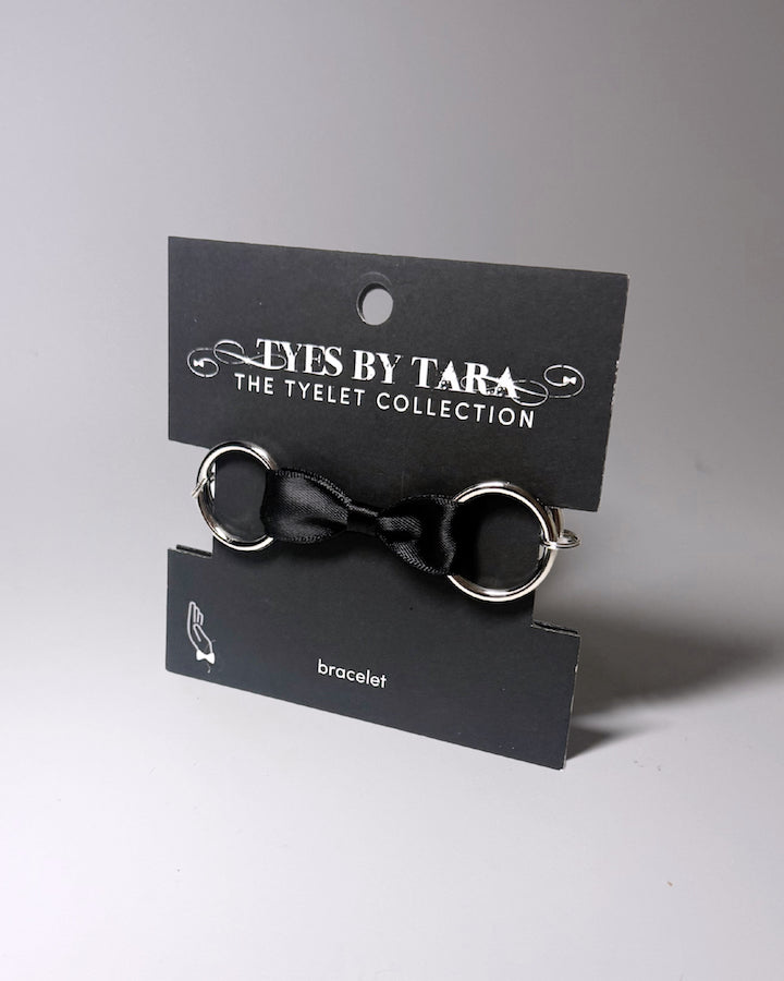 Packaging View of Runaway Bow Bracelet on Black Card