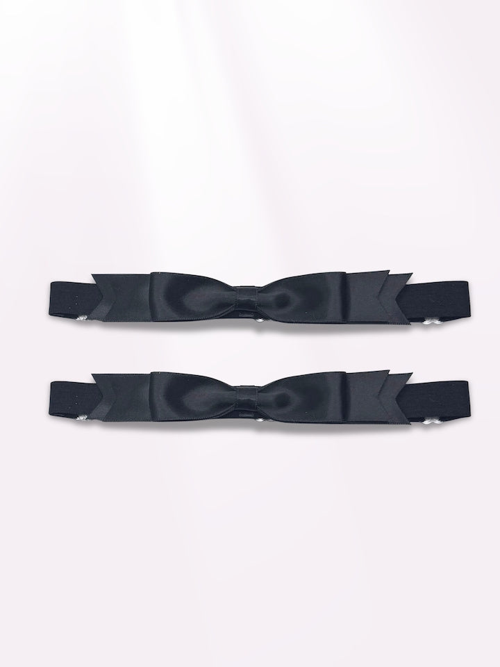 black enchantress bow leg garters on light pink background