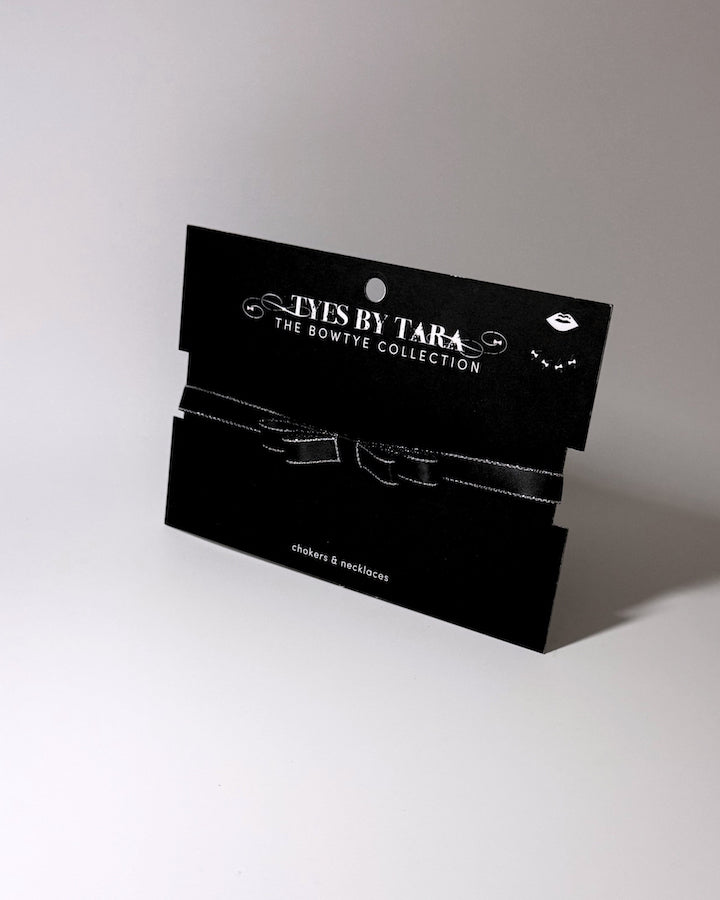 black metallic trimmed bow choker packaging