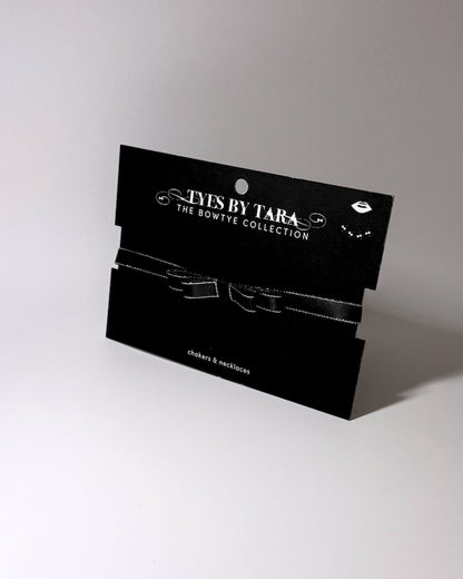 black metallic trimmed bow choker packaging