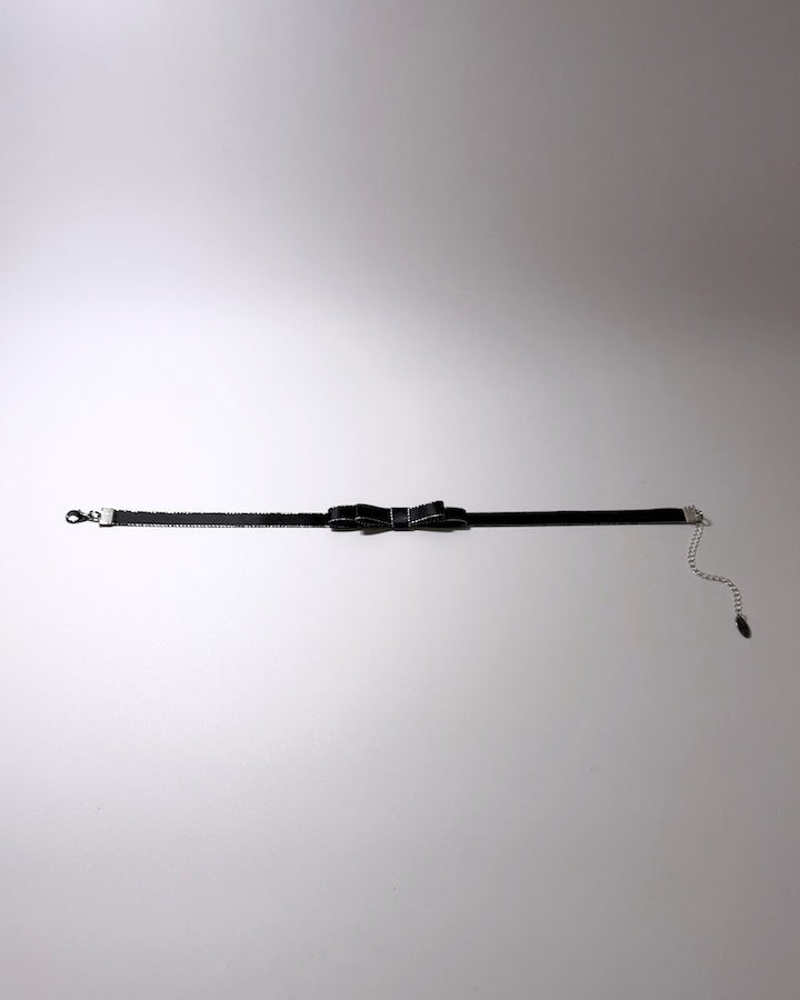 black metallic trimmed bow choker flatlay