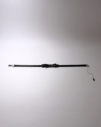 black metallic trimmed bow choker flatlay