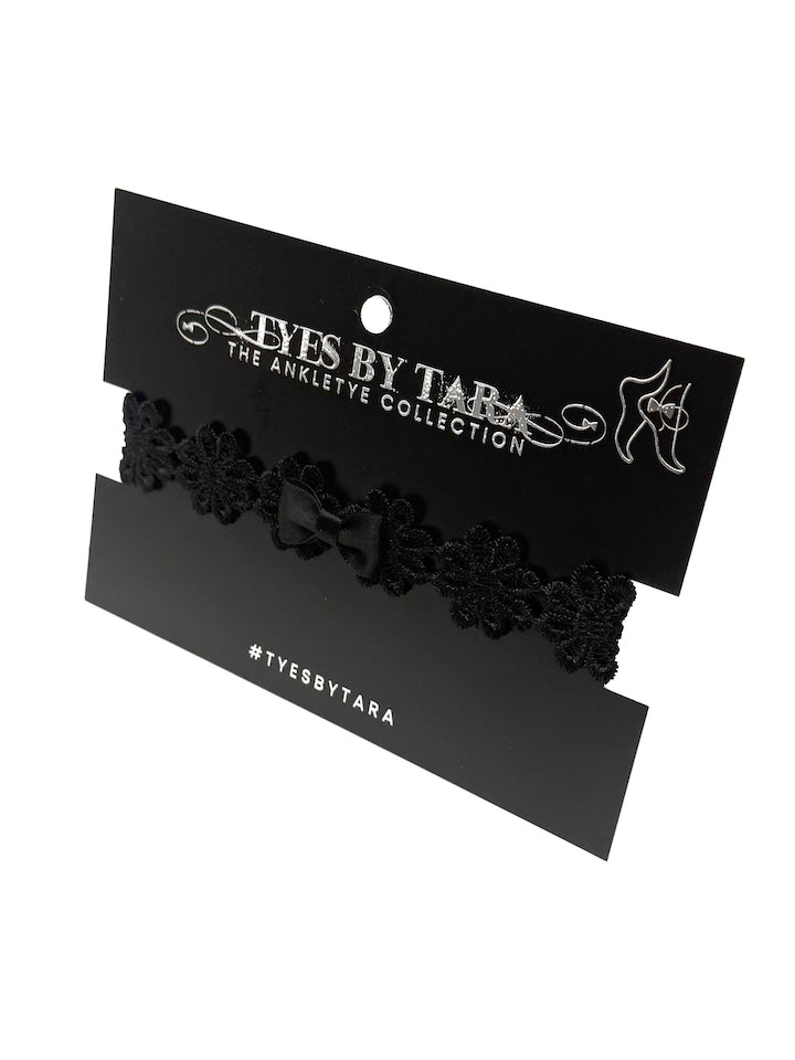 black flower bow anklet on black card